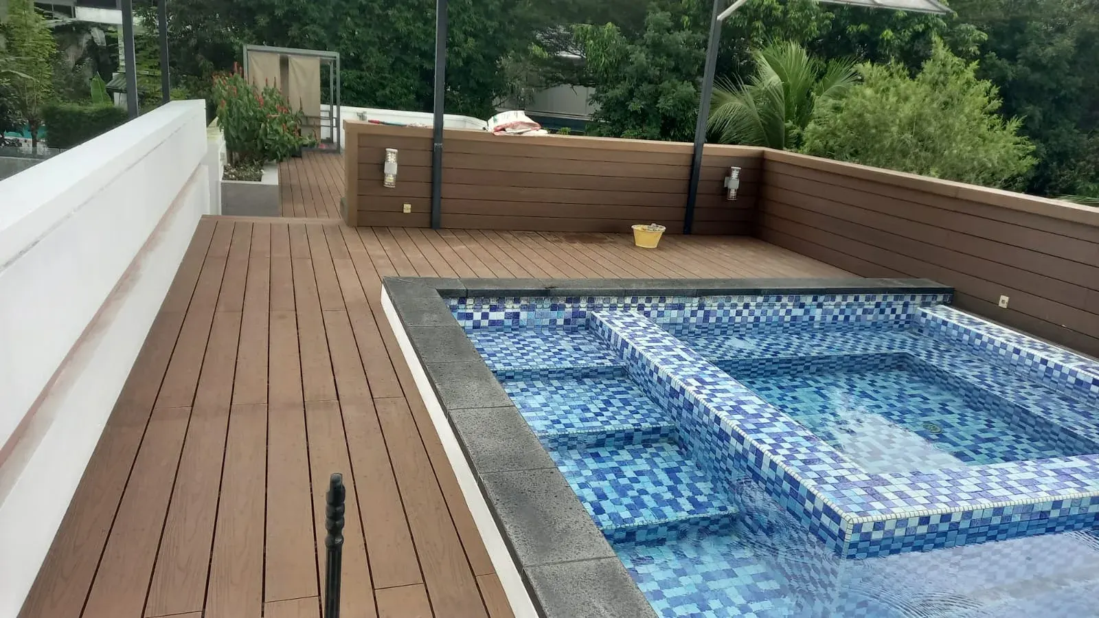 Composite timber deck surrounding a swimming pool