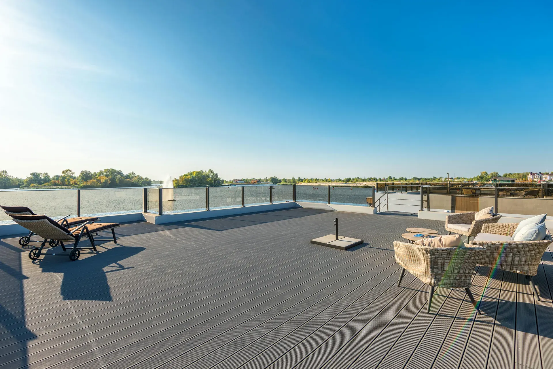 Outdoor composite deck with timber-look boards and planting alongside